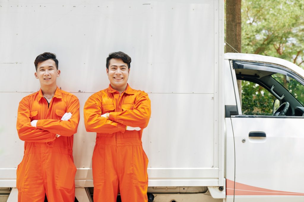 Smiling movers in orange uniform