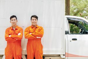 Smiling movers in orange uniform
