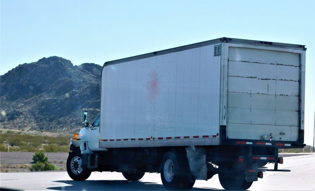 Transportation and Logistics! A big rig box truck parked in the remote landscape.